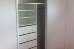 White Vinyl Sliding Robe Doors and Internal Cabinetry.